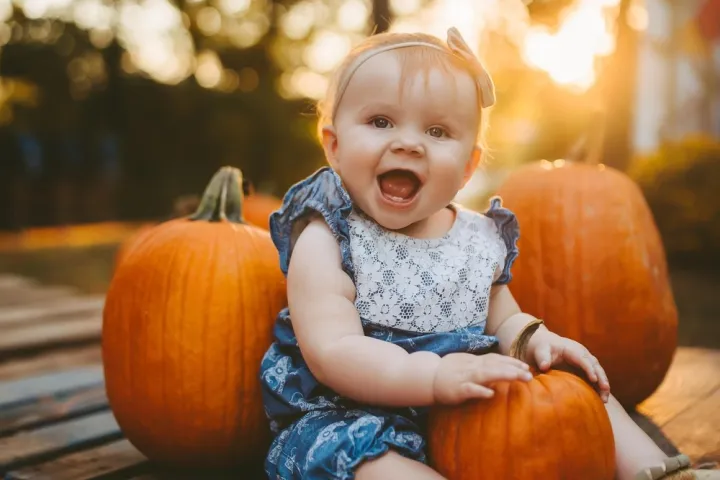 a little girl sitting on a table
