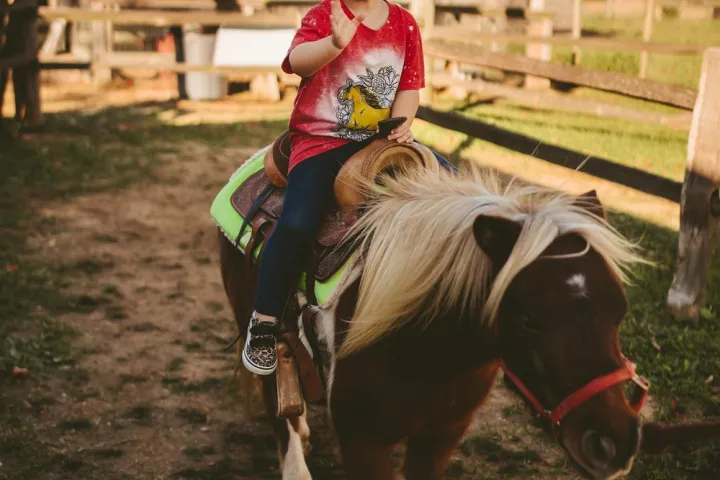 a young man riding a horse