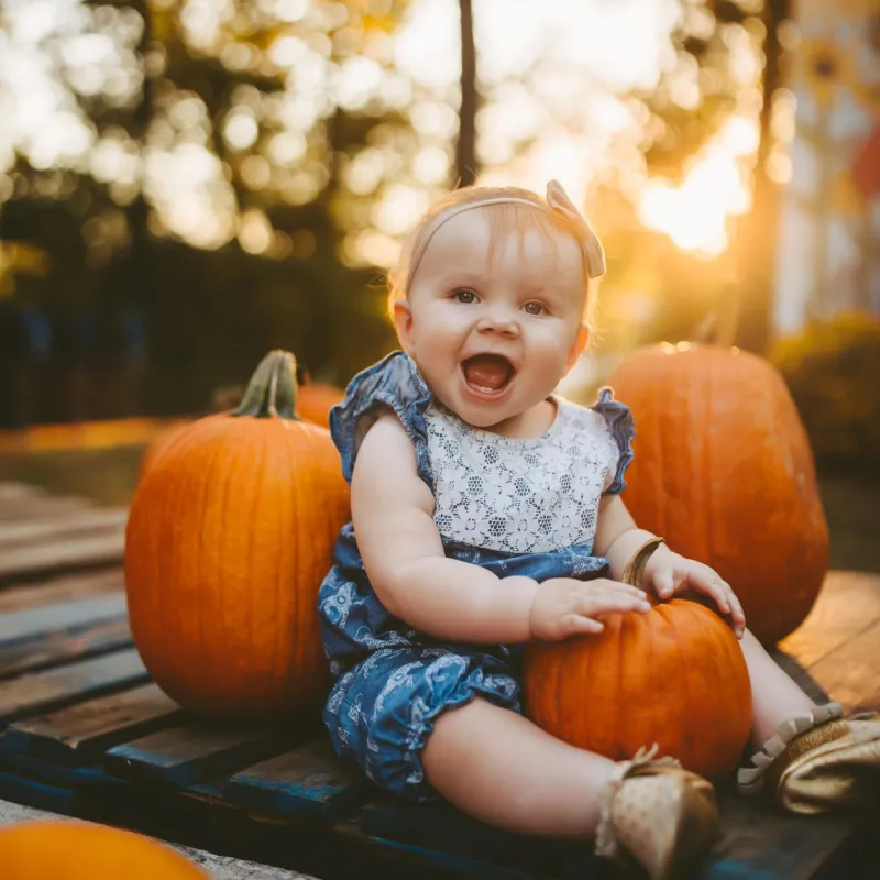 a little girl sitting on a table